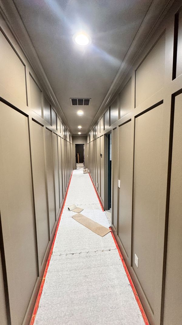 A commercial corridor with tall dark wainscot panels