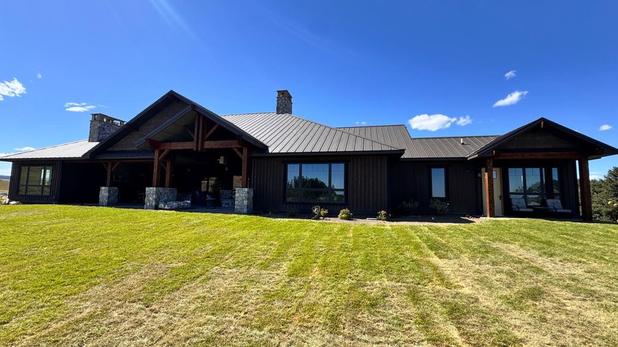 The back of a custom home across a fresh lawn